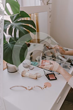 Everyday beauty routine. Make up artist. Dressing vanity. Women& x27;s hands. Pastel colors. In front of the mirror. Palettes