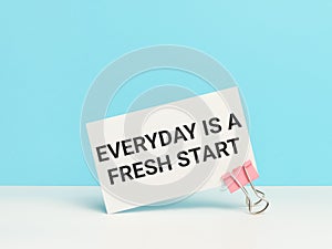 Everyday is a fresh start written on white card with paper clip.
