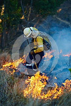 Everyday heroism. Shot of fire fighters combating a wild fire.