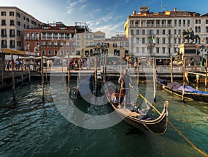 Everyday life of a gondolier. Walking on the bridges of the old city of Venice. Bright sun. The beauty of the ancient city. Italy