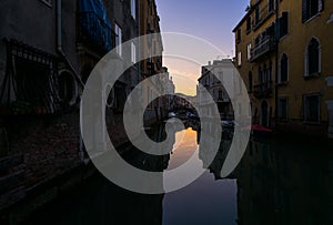 Everyday life of a gondolier. Walking on the bridges of the old city of Venice. Bright sun. The beauty of the ancient city. Italy