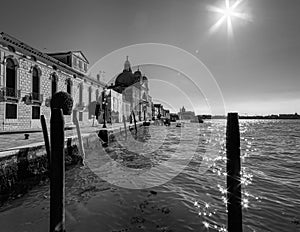 Everyday life of a gondolier. Walking on the bridges of the old city of Venice. Bright sun. The beauty of the ancient city. Italy