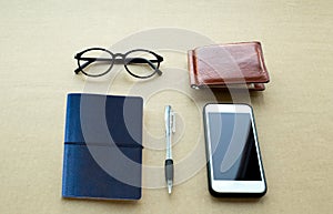 Everyday life object needs notebook and pen ,cell phone and gla