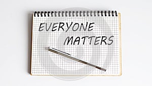 Everyone Matters written on a notepad with pen