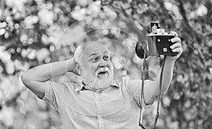 Everyone photogenic. Senior man taking selfie photo vintage camera. Self portrait. Memories in snap. Retro equipment for