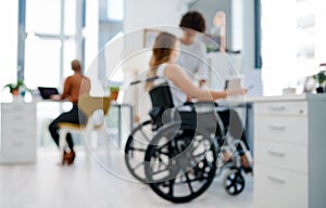 Everyone works together in our office. Shot of a businesswoman with disabilities working with colleagues in a modern