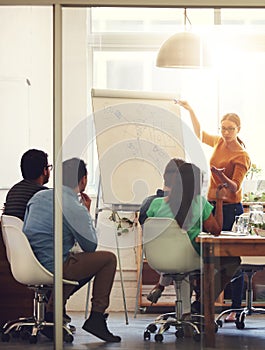 Everyones ideas are important. a group of coworkers in a boardroom meeting.