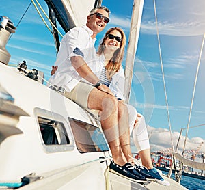 Everything is better by the sea. a couple enjoying a boat cruise out on the ocean.