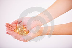 Everything the body needs...Cropped image of a womans hands holding a bunch of vitamins.