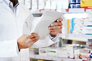 Everything is digitized in this pharmacy. Closeup shot of an unrecognizable pharmacist using a digital tablet in a
