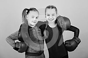 Everything is possible. Happy children sportsman in boxing gloves. workout of small girls boxer in sportswear. punching