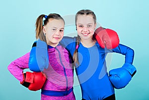 Everything is possible. Happy children sportsman in boxing gloves. workout of small girls boxer in sportswear. punching