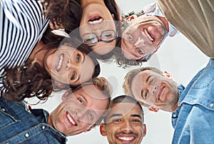 Everything is possible with a team of creative minds. Low angle shot of six people putting their heads together in a