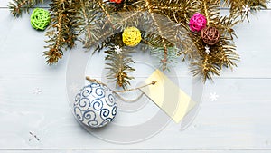 Everything you need to decorate christmas tree. Christmas holidays concept. Decorative ball toy and gift tag copy space