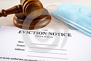 Eviction notice, notice to quit document with facial mask and gavel