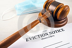 Eviction notice, notice to quit document with facial mask and gavel