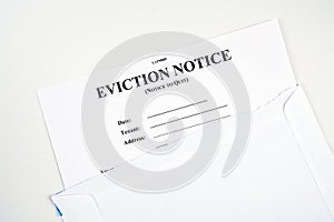 Eviction notice, notice to quit document form in envelope isolated on white.