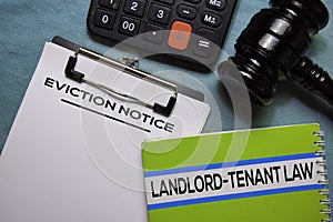 Eviction Notice text on Document form and book Landlord-Tenant Law isolated on office desk.