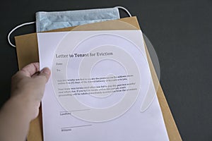 Eviction notice on top of  envelope and face mask