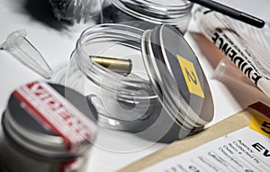 Evidence of crime scene, bullet cap in laboratory scientist, conceptual image