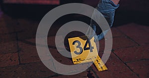 Evidence marker, hand of csi and crime scene with forensic on floor at night for investigation of murder. Professional