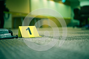 Evidence marker number 7 on carpet floor near suspect object in
