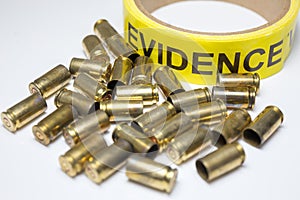 Evidence tape with brass bullet cases focus on evidence word