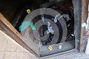 Evidence with yellow CSI marker for evidence numbering on the residental backyard in evening. Crime scene investigation concept