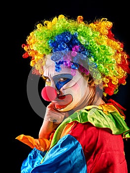 Evil clown on black background. Portrait of crazy woman.