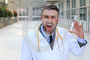 Evil doctor holding a syringe in hospital