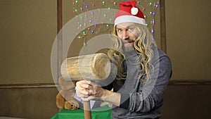 Evil dwarf or bad santa gifts guards with a wooden mallet