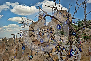 Evil eye charms hang from a bare tree in Cappadoci