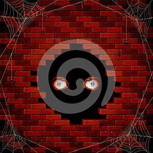 Evil eyes in the hole of the brick wall and spiders