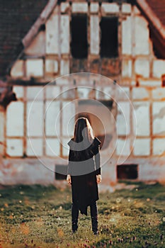 Evil Ghost in Front of a Horror Haunted Abandoned House