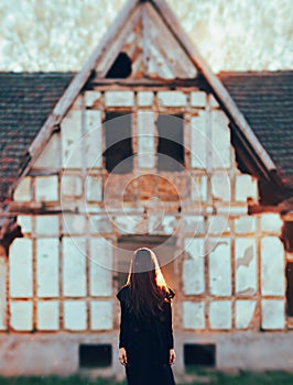 Evil Ghost in Front of a Horror Haunted Abandoned House