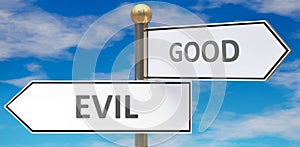 Evil and good as different choices in life - pictured as words Evil, good on road signs pointing at opposite ways to show that