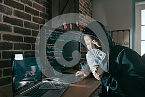 Evil hacker holding cash banknote cover face