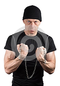 Evil man in black with chain in hands on white