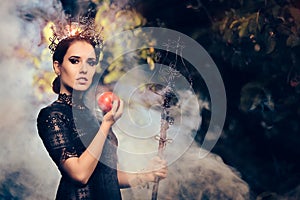 Evil Queen with Poisoned Apple in Misty Forest