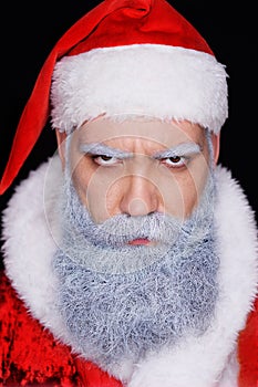 Evil Santa Claus angrily looks at the camera