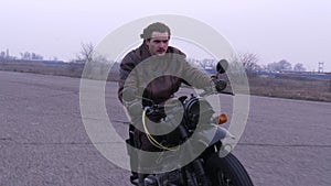 An evil sight of emotional man on vintage motorcycle in pursuit