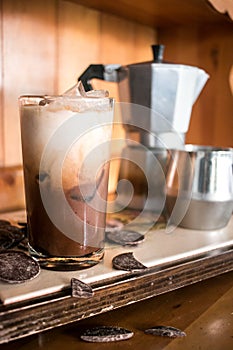 Evocative glass of iced coffee with delicious chocolate everywhere