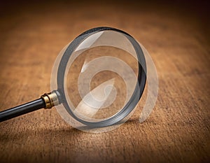 Vintage Brass Magnifying Glass on Warm Textured Background