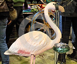 Garden flamingo statue with 70`s ashtray at a vintage market photo