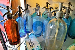 Old soda water bottles in an antique shop photo