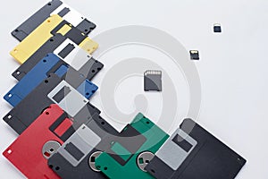 The evolution of digital data storage device. Floppy disks vs small memory cards. Isolated on a white background