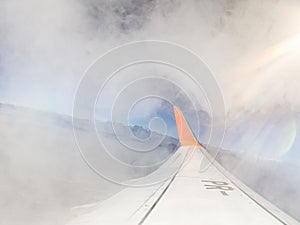 Airplane wing going through a cloud