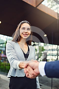 Exactly who she wanted to meet. a beautiful young businesswoman shaking hands with an unrecognizable businessman outside