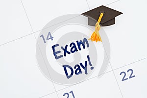 Exam day message with a calendar with a grad hat