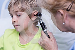 Examinating by otoscope photo